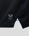 Close up of black Away Pro shirt hem showing Castore authentication patch and white trim