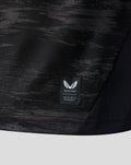 Lower hem close up showing Castore Authentic Product badge on black goalkeeper shirt