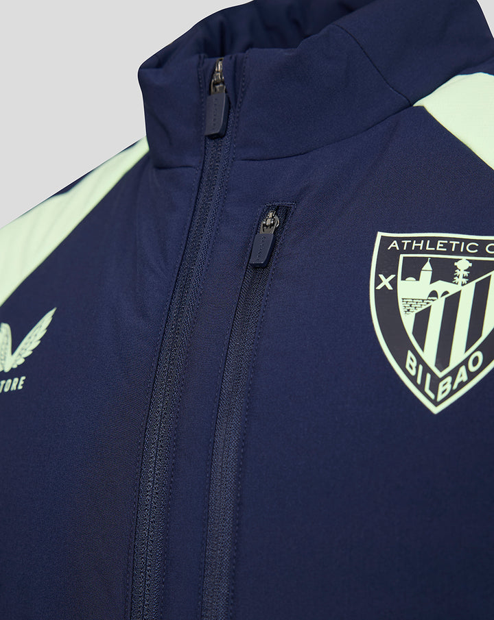 Navy performance gilet with crest emblem on the chest and front zipper.