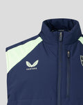 Close up of navy gilet chest area showing front zip Castore logo on left and shield crest on right