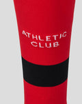 Close up of red Away Change sock with black band and white Athletic Club lettering