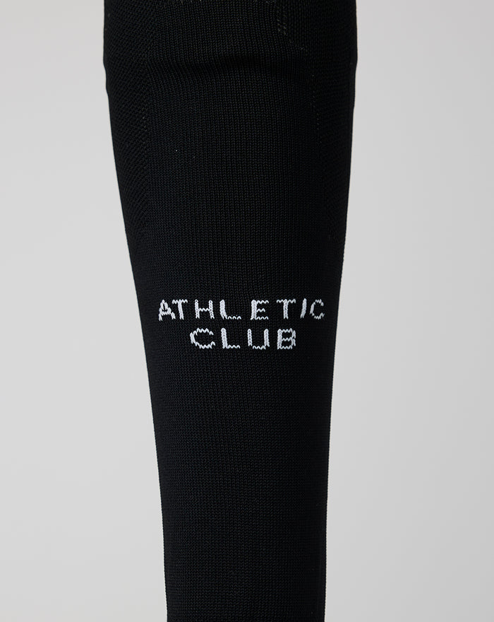 Black Home goalkeeper sock with white Athletic Club lettering along the calf.