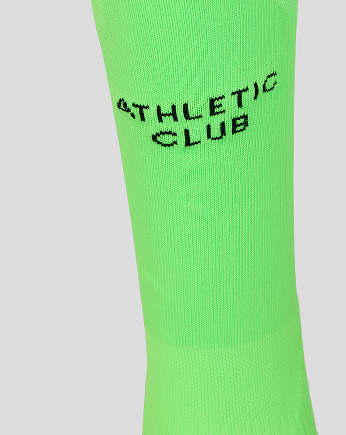 Bright neon green goalkeeper sock in close up with black Athletic Club branding.