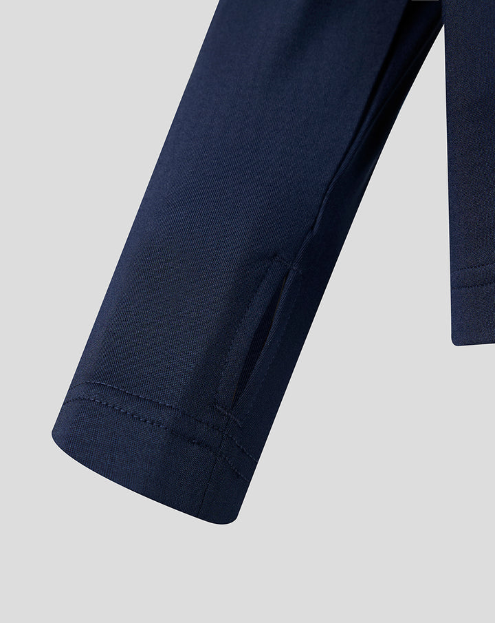 Close up of navy performance midlayer sleeve with hem detail