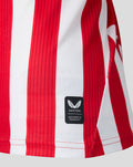 Close up of the red and white striped hem with Castore authentic product badge.