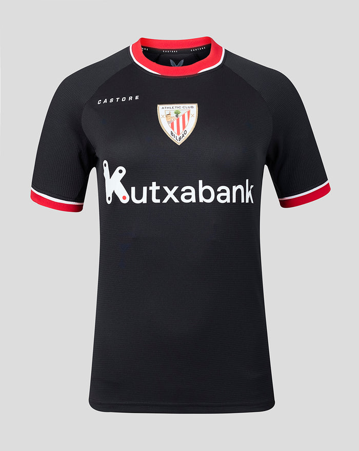 Black away short sleeve women's sports shirt with red trim, crest on chest and Kutxabank sponsor logo across the front.