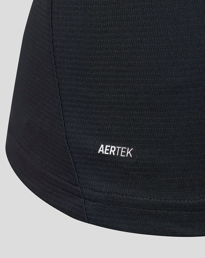 Close-up of black knit fabric with AERTEK branding at the hem of the women's away short sleeve shirt.