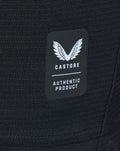 Close-up of black knit fabric with a Castore authentic product tag.