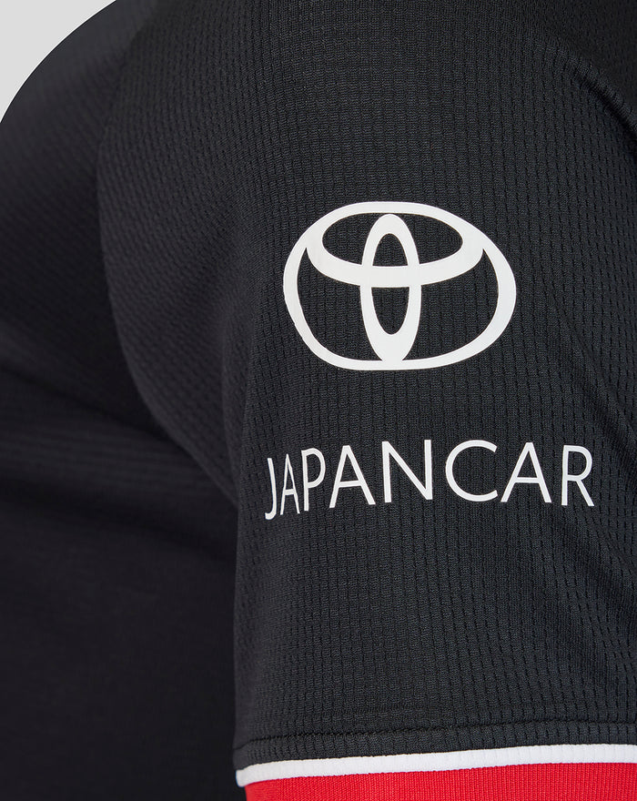 Back view of black away short sleeve shirt with red collar trim and a small neck patch at the upper back.