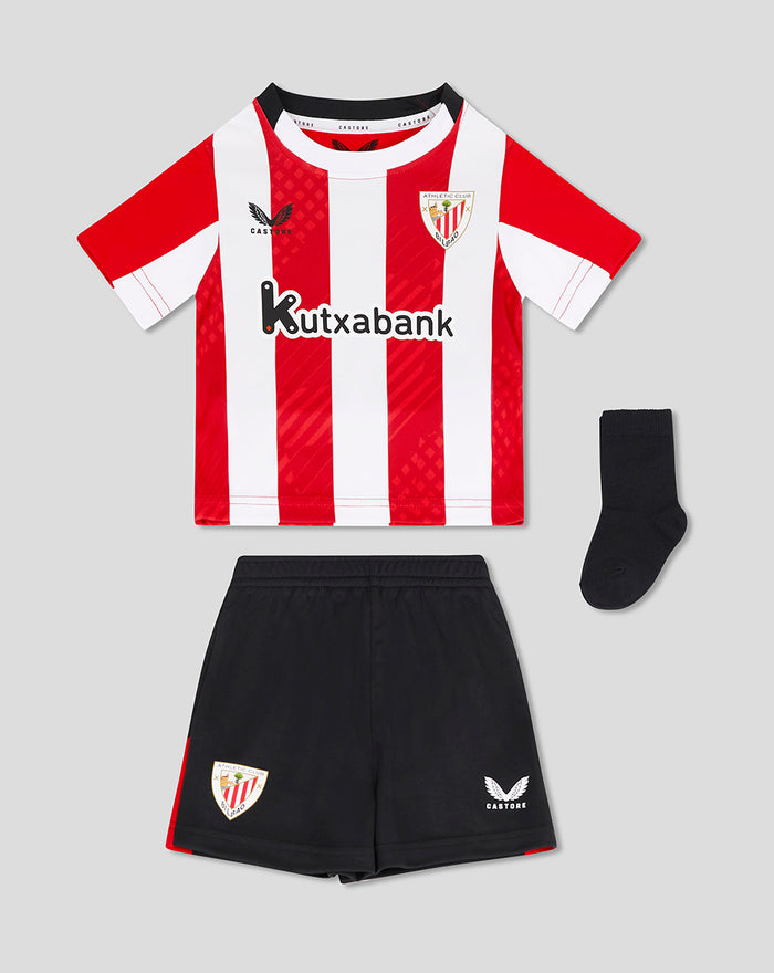Baby home nested kit laid out with red and white striped shirt black shorts and a sock