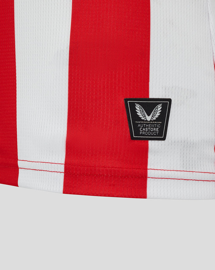 Close-up of red and white striped Athletic Club shirt hem with a Castore authentic patch.