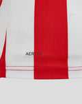 Back view of red Athletic Club jersey with white side panels and a black collar with white trim and a small crest at the upper back.