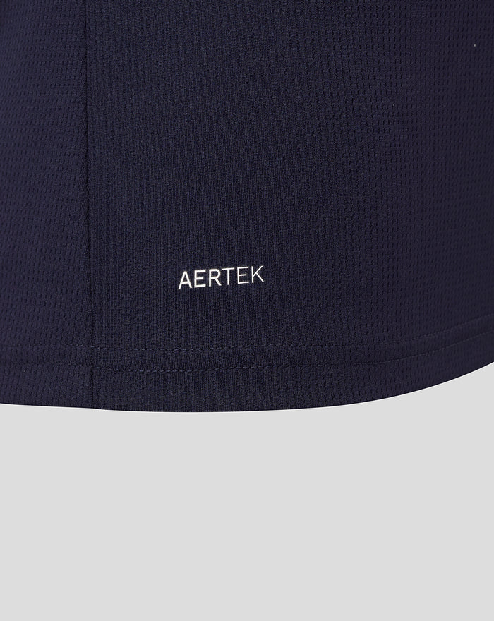 Close up of navy fabric showing AerTek branding near the hem.