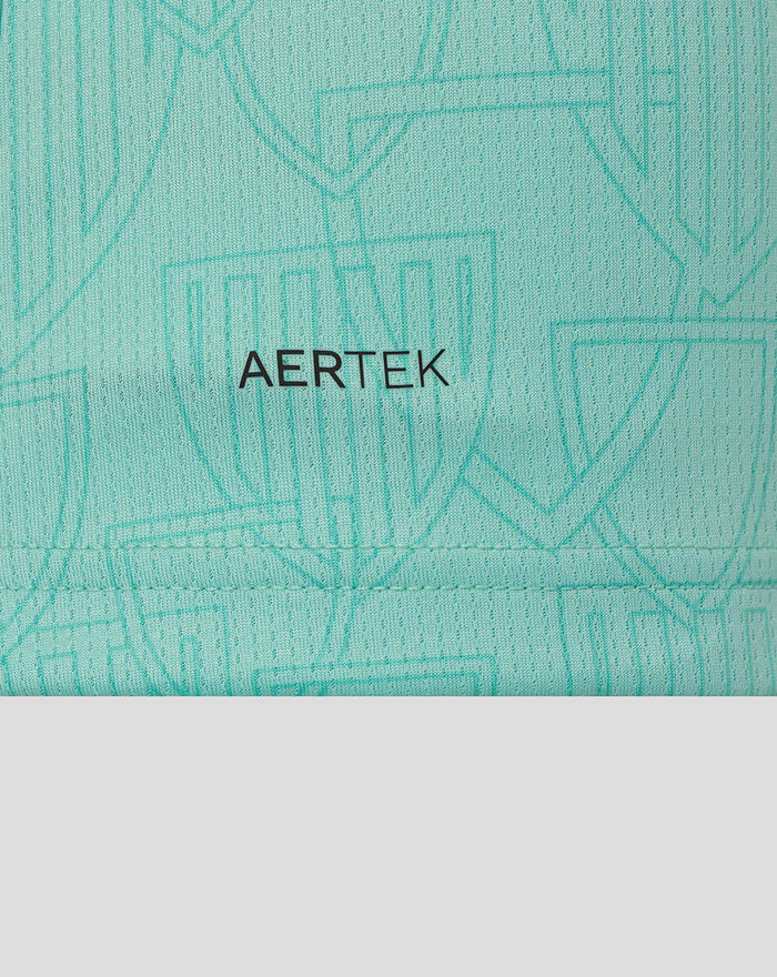 Collar area of turquoise Athletic Club shirt with Castore branding on the neckline.