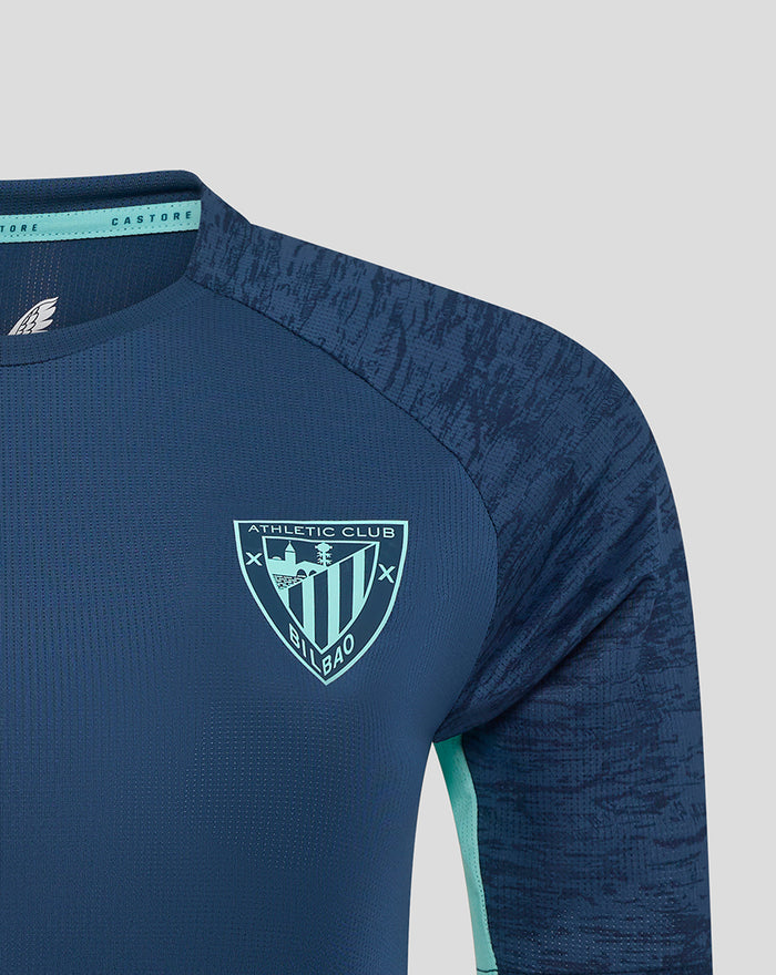 Close-up of women's navy Athletic Club training tee showing left chest crest and right chest Castore logo.