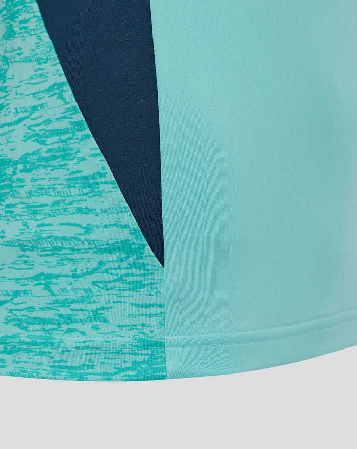 Close up of teal and navy color block fabric from an Athletic Club performance midlayer top
