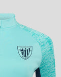 Front of turquoise athletic club midlayer top showing left chest crest and quarter-zip collar.