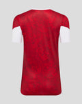 Back view of red floral patterned Athletic Club home pre match short sleeve tee with white sleeve cuffs.