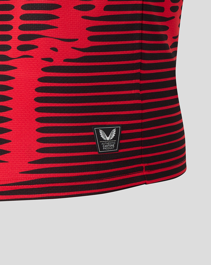 Close up of the Athletic Club 4th kit shirt showing red and black stripes and the authentic Castore product patch near the hem