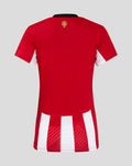 Back view of a red women's home soccer jersey with bold red body and white vertical striped hem at the bottom