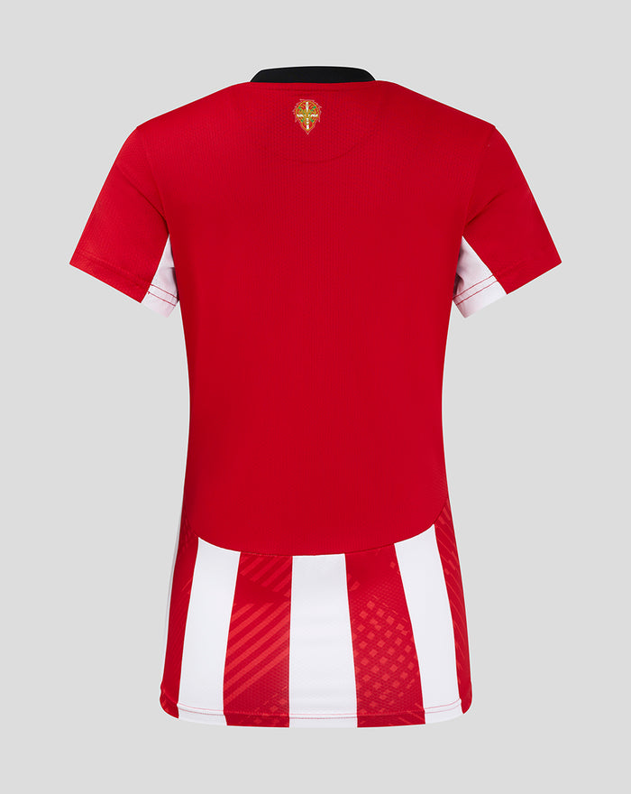 Back view of a red women's home soccer jersey with bold red body and white vertical striped hem at the bottom