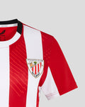 Close up of shoulder and chest on a red and white striped jersey with a crest on the left chest and black collar trim