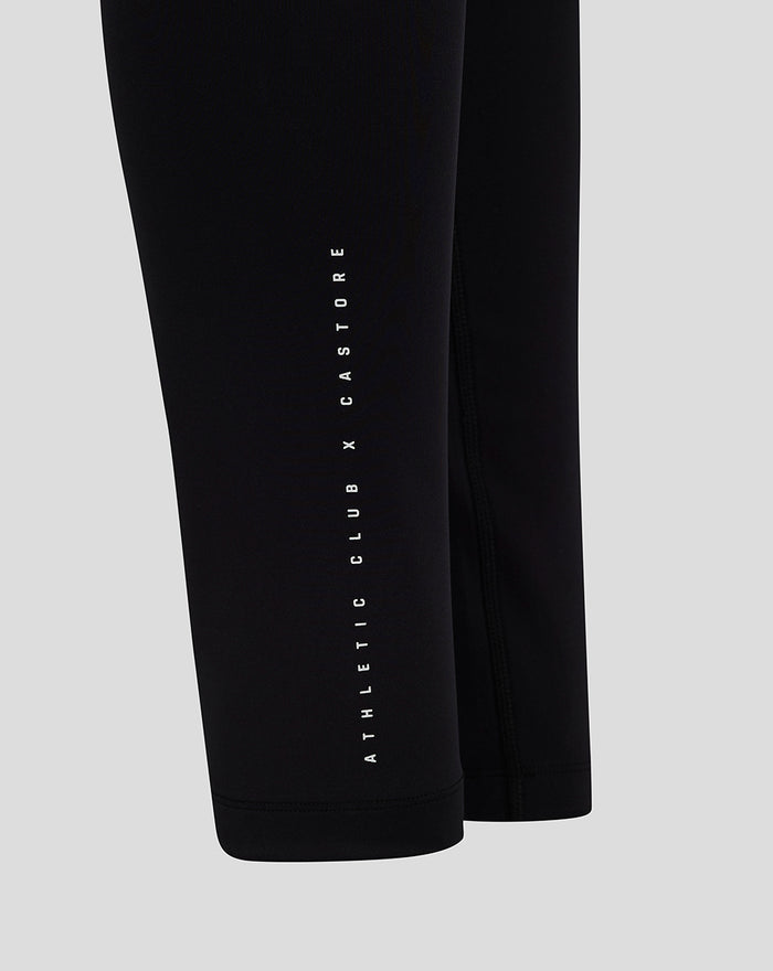 Close up of black leggings with vertical white branding along the leg reading ATHLETIC CLUB CASTORE
