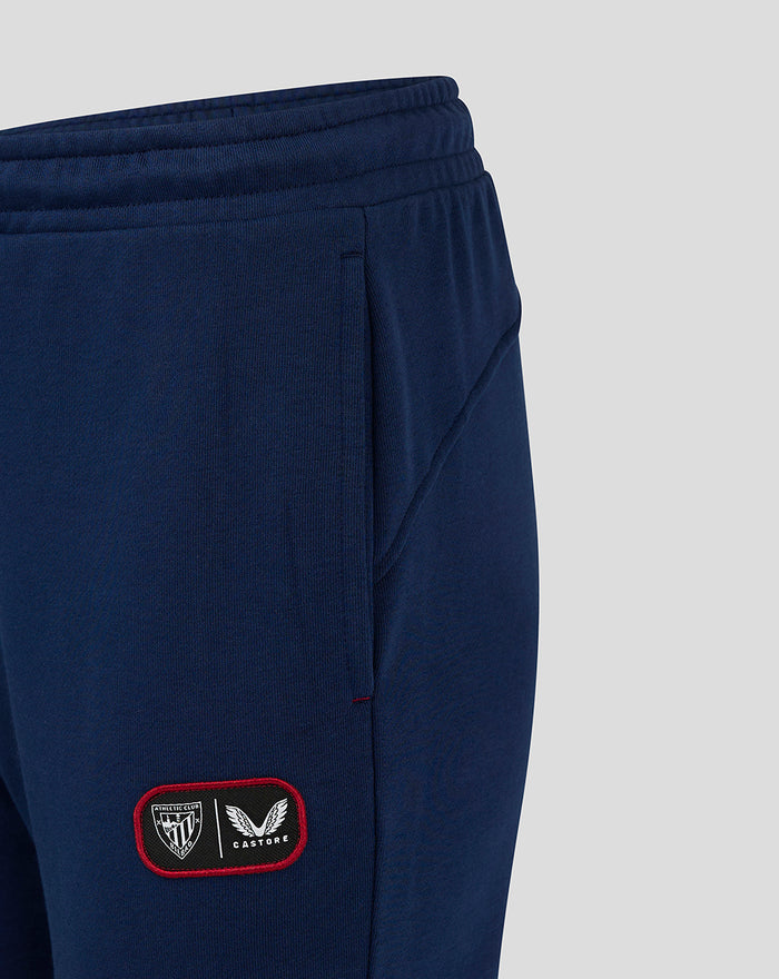 Navy women's Club Jogger fabric close up with a red bordered patch on the leg