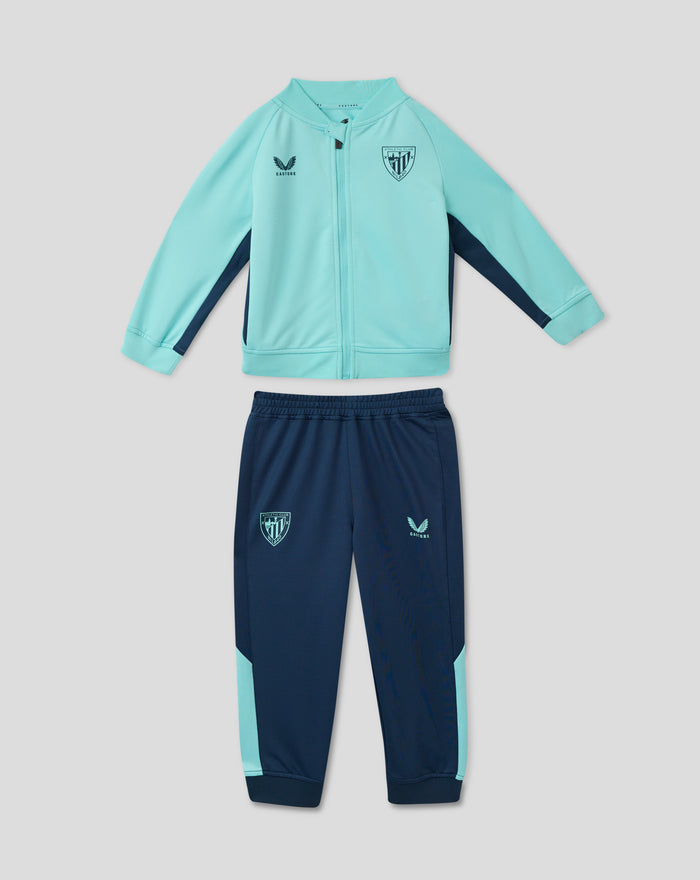 Infant Athletic Club performance knit suit outfit with turquoise jacket showing crest on chest and Castore logo, paired with navy shorts