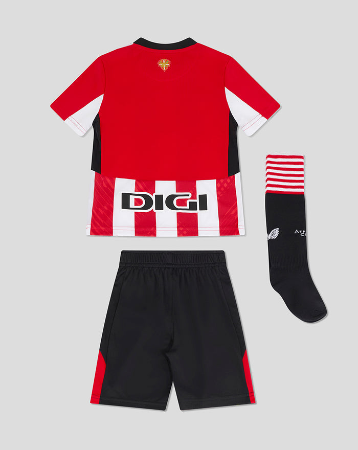 Infant home kit laid flat featuring a red shirt with white and red stripes, black shorts, and a black sock with a red top band