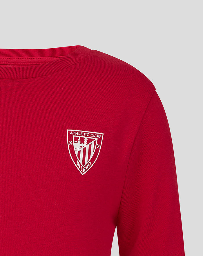 Red junior Athletic Club Crest tee with a white shield emblem on the chest.