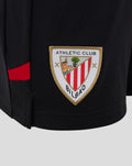 Athletic Club crest patch on black junior home shorts with a red side stripe