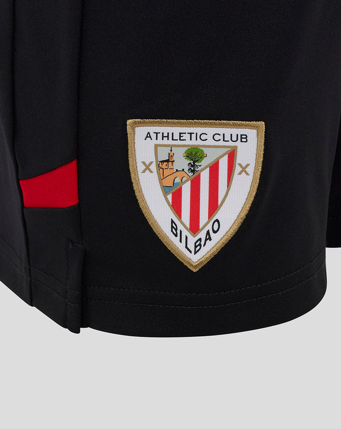 Athletic Club crest patch on black junior home shorts with a red side stripe