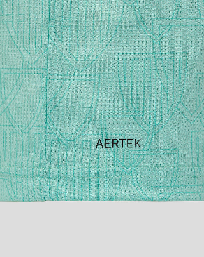 Close-up of turquoise AerTek fabric showing a subtle crest pattern and neat hem stitching.