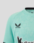 Bright turquoise Junior Athletic Club Third Short Sleeve shirt close up of front with Castore logo and Athletic Club crest on the left chest