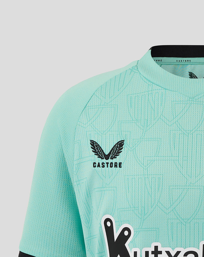 Bright turquoise Junior Athletic Club Third Short Sleeve shirt close up of front with Castore logo and Athletic Club crest on the left chest