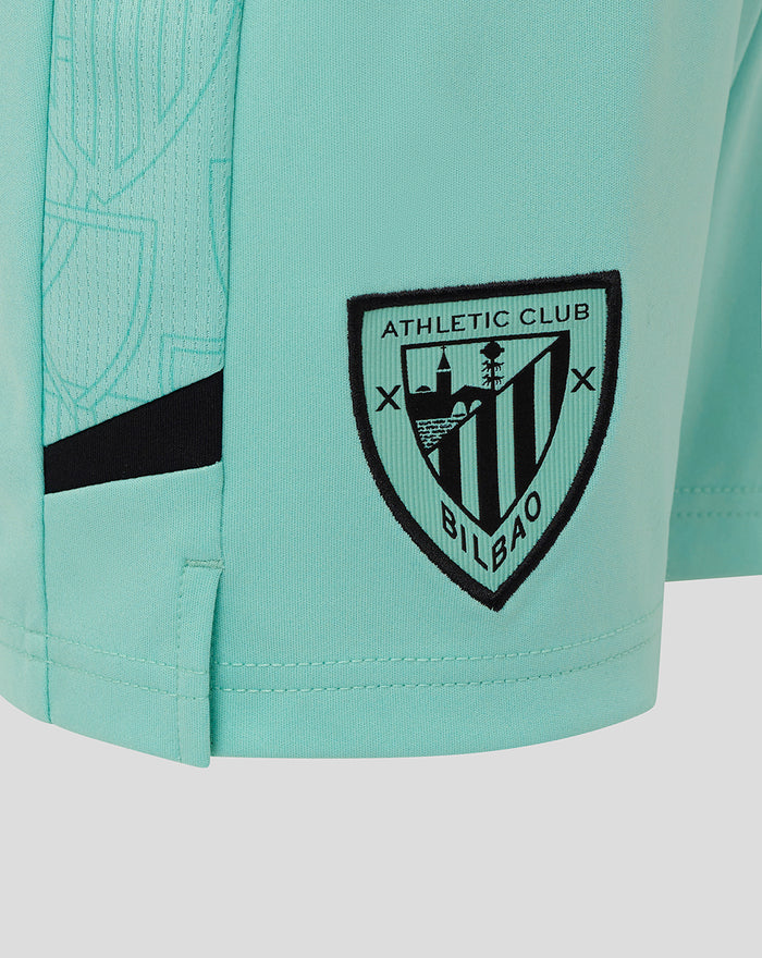 Turquoise junior Athletic Club third shorts close up with Castore logo on left thigh and crest on right thigh