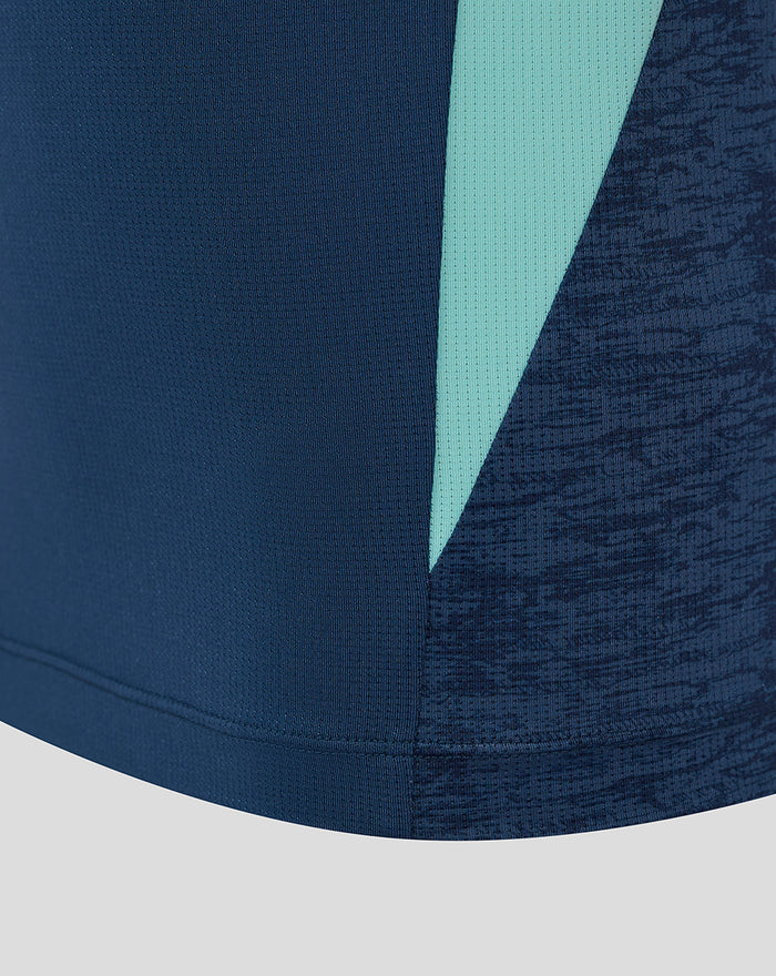Close-up of navy athletic club tee showing teal side stripe and textured knit fabric.