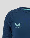 Front close-up of navy athletic club junior tee showing a light blue crest on the chest and Castore branding.
