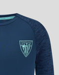 Navy athletic club junior tee close-up with crest on left chest and Castore logo on right.