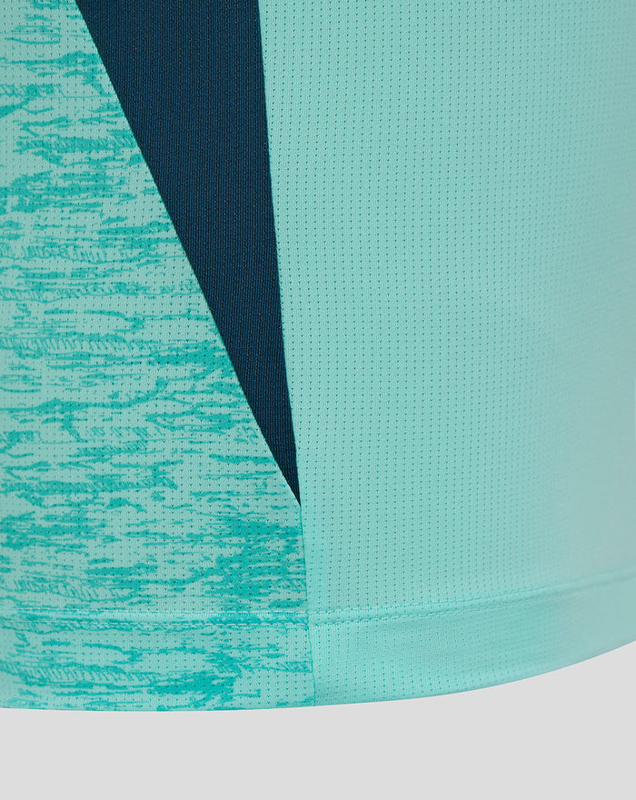 Close-up of teal and navy color blocked fabric detailing on athletic club tee.