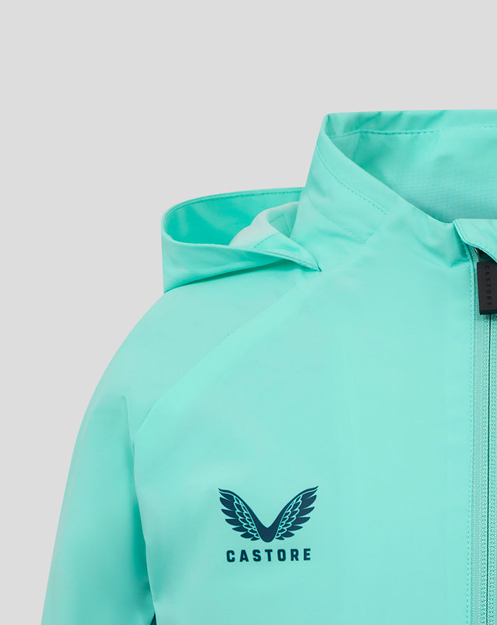 Close-up of aqua jacket chest area showing Castore logo and zipper.
