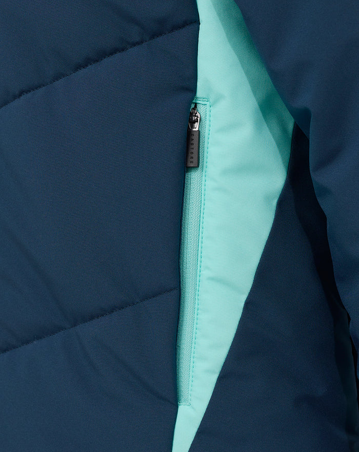 Close-up of navy blue jacket showing a turquoise zip pocket with mint lining