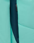 Teal padded jacket close up showing a navy zipper with a surrounding navy panel along the front