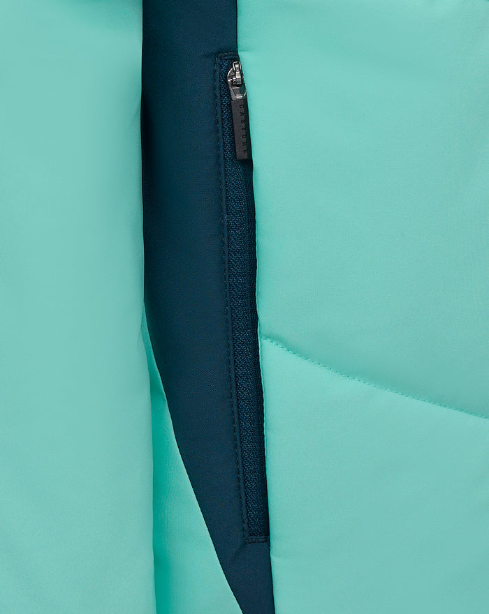 Teal padded jacket close up showing a navy zipper with a surrounding navy panel along the front
