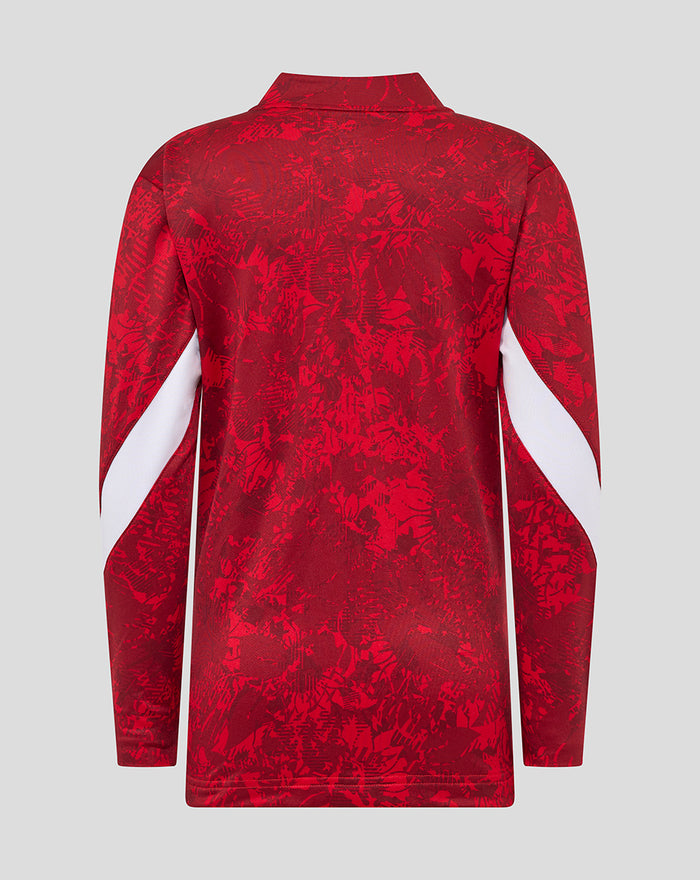 Back view of red junior Athletic Club Home Pre Match Midlayer Top with abstract print and white sleeve accents.