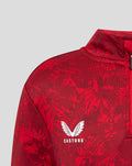 Close up of red Athletic Club Midlayer showing Castore logo and Athletic Club crest on the chest