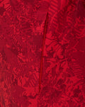Close up of red fabric with an abstract pattern and a vertical zip from the Junior Athletic Club Home Pre Match Jacket