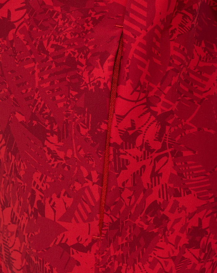 Close up of red fabric with an abstract pattern and a vertical zip from the Junior Athletic Club Home Pre Match Jacket