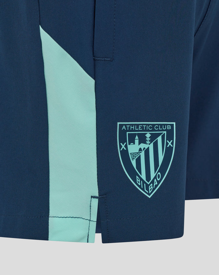 Navy junior woven shorts with a light turquoise side stripe and Athletic Club crest.